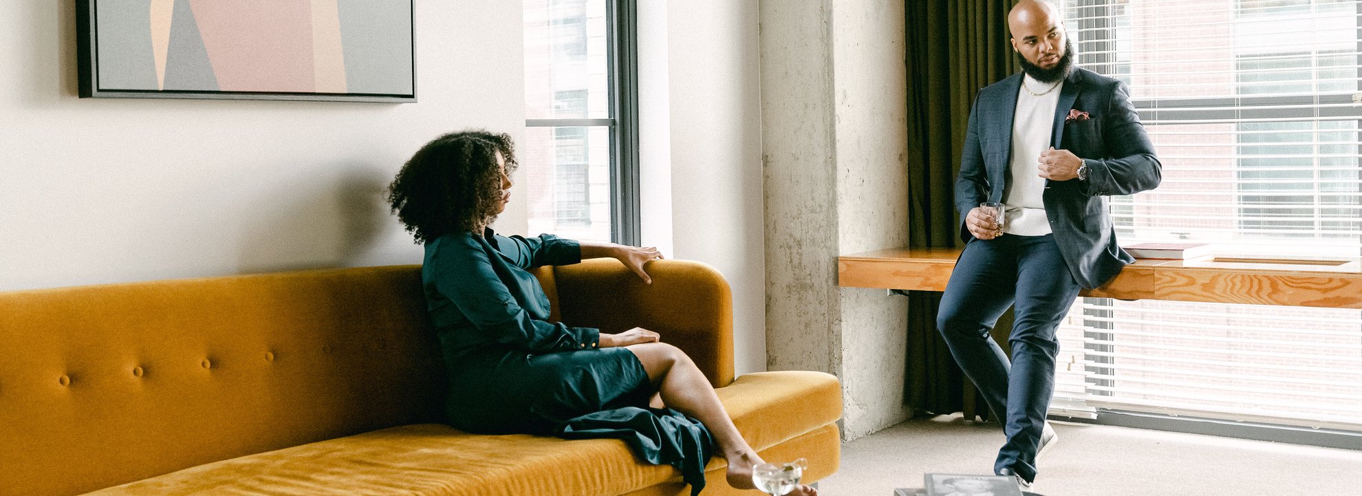 A couple sitting in the loft suite with drinks on hand