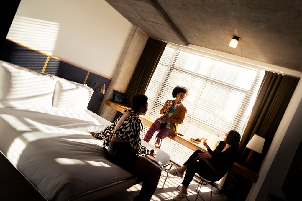 three girls having conversation in the room at the emily hotel chicago