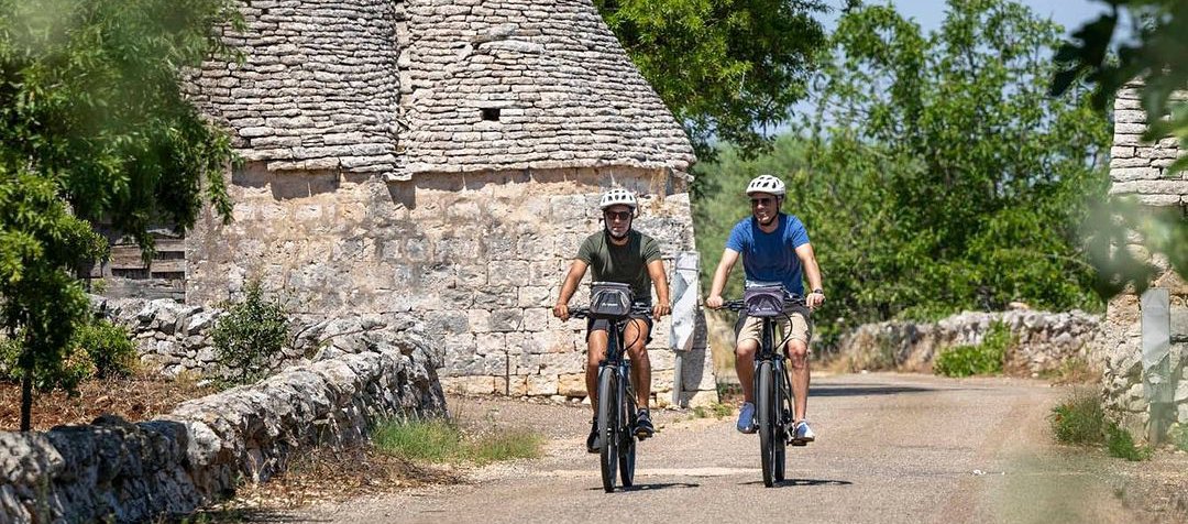 Two bikers by a trulli in Puglia