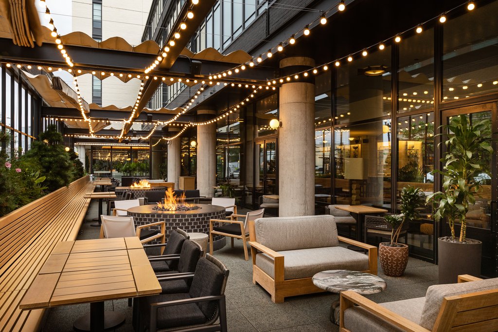 patio with fireplace and seating area at Fora chicago, the emily hotel