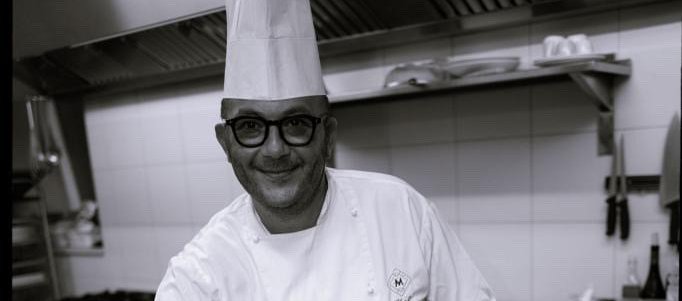 Chef Giovanni Vito plating a dish at Villa Torre Bianca