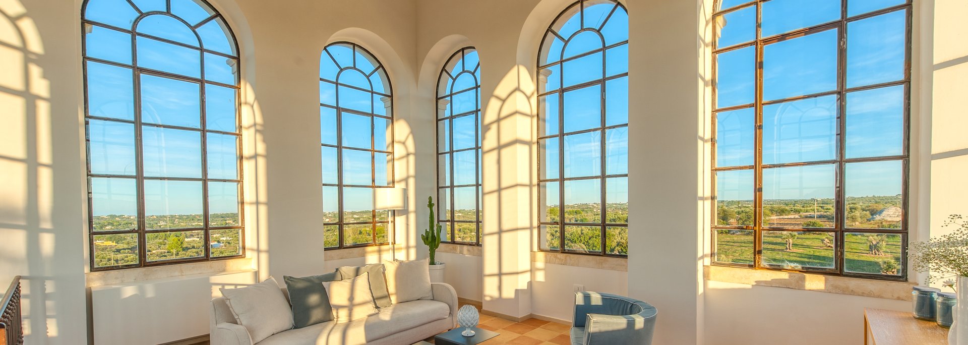 living area with large windows in the Torre Bianca Suite