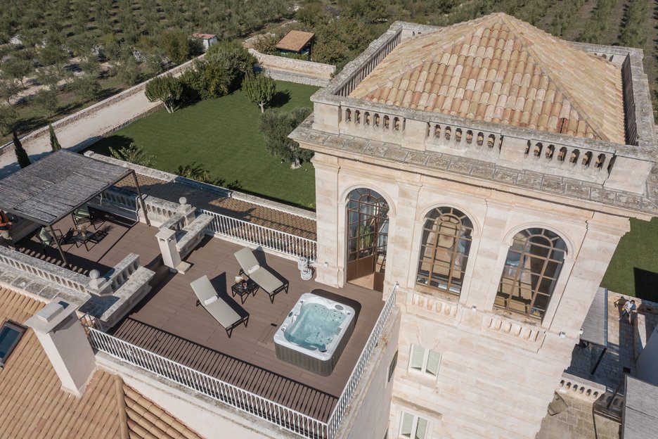 two lounge chairs and outdoor patio hot tub in torre bianca suite at villa torre bianca by emily hotels in puglia italy