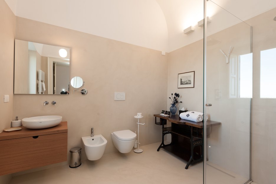 bathroom with single sink and standing shower in rosa suite at villa torre bianca by emily hotels in puglia italy