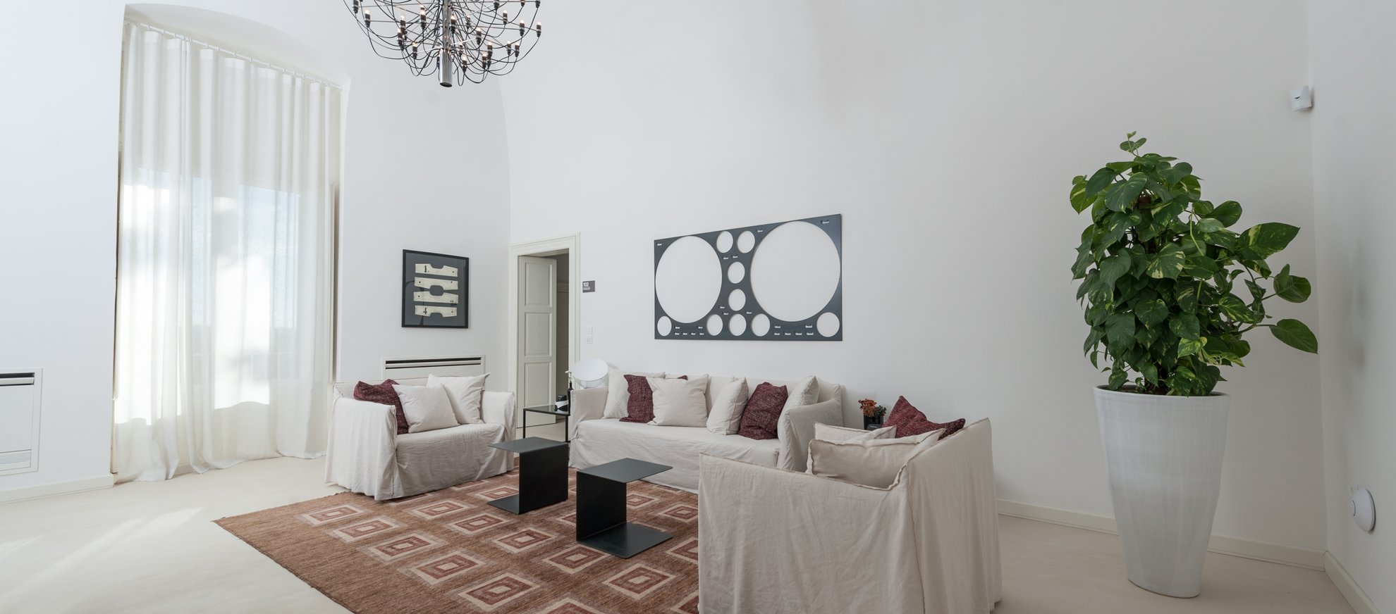 spacious living space with couches in rosa junior suite at villa torre bianca by emily hotels