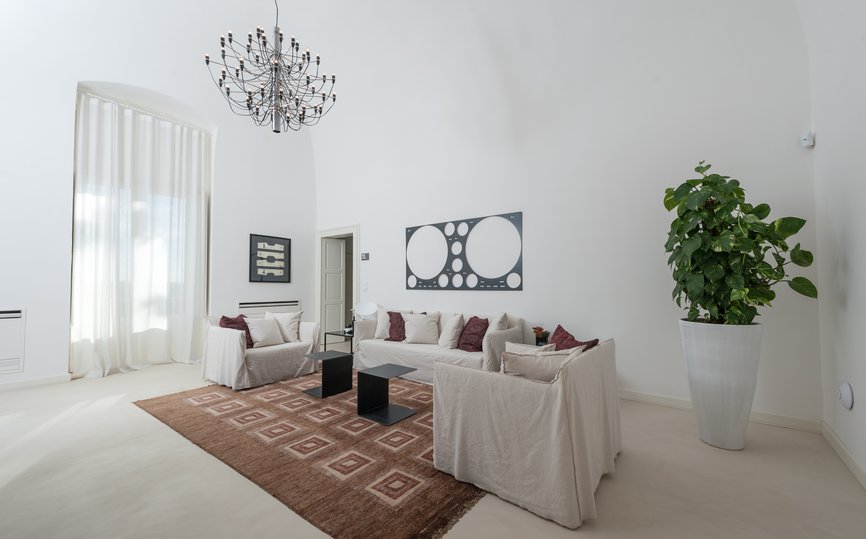 spacious living space with couches in rosa junior suite at villa torre bianca by emily hotels