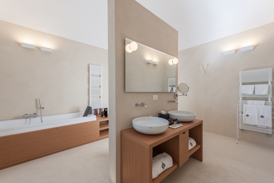 shower tub and two bathroom sinks in rosa junior suite at villa torre bianca by emily hotels in puglia italy