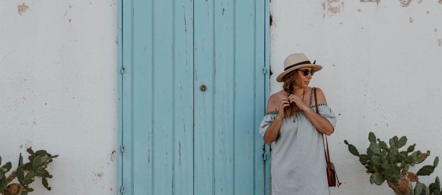 Girl in Puglia in front of blue door