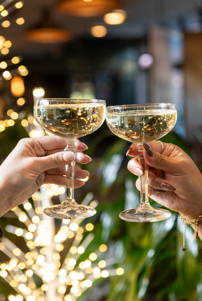 signature cocktail drinks with festive background at fora chicago the emily hotel fulton market