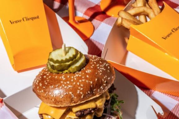 picnic package table spread of fora burger fries in veuve clicquot box, veuve clicquot glasses