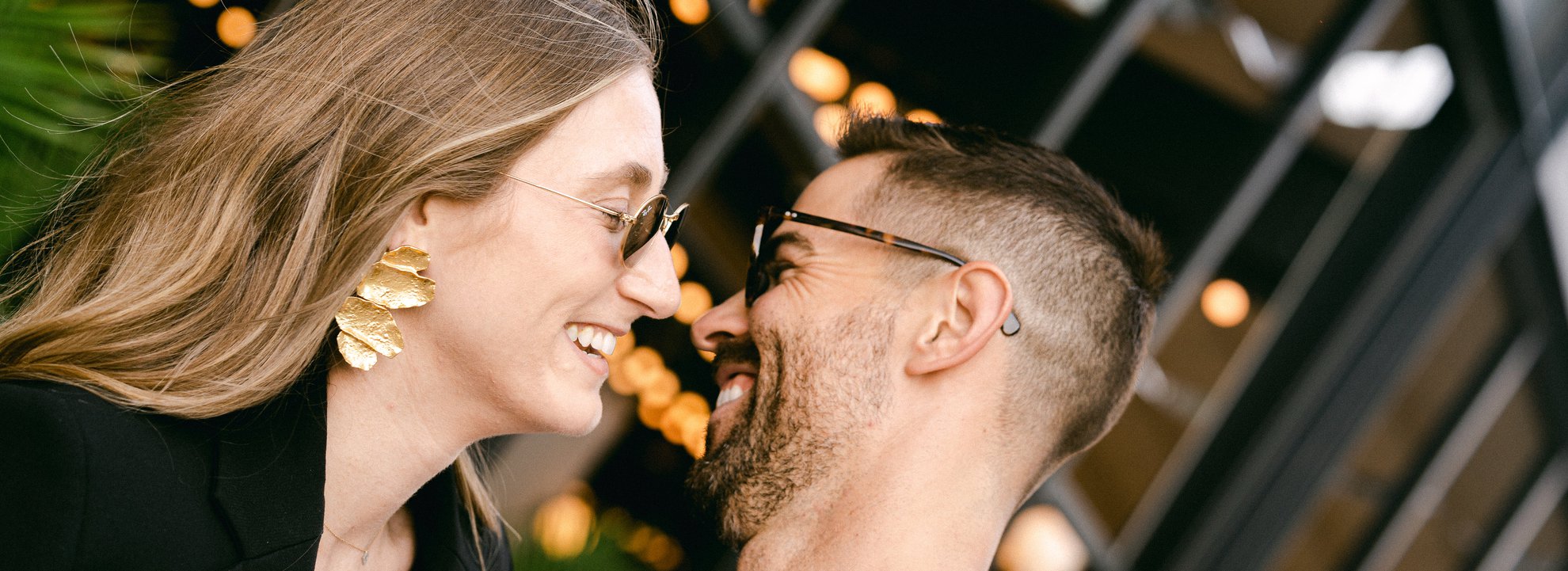 a couple having a romantic moment in front of the emily hotel with the background of patio at fora chicago fulton market