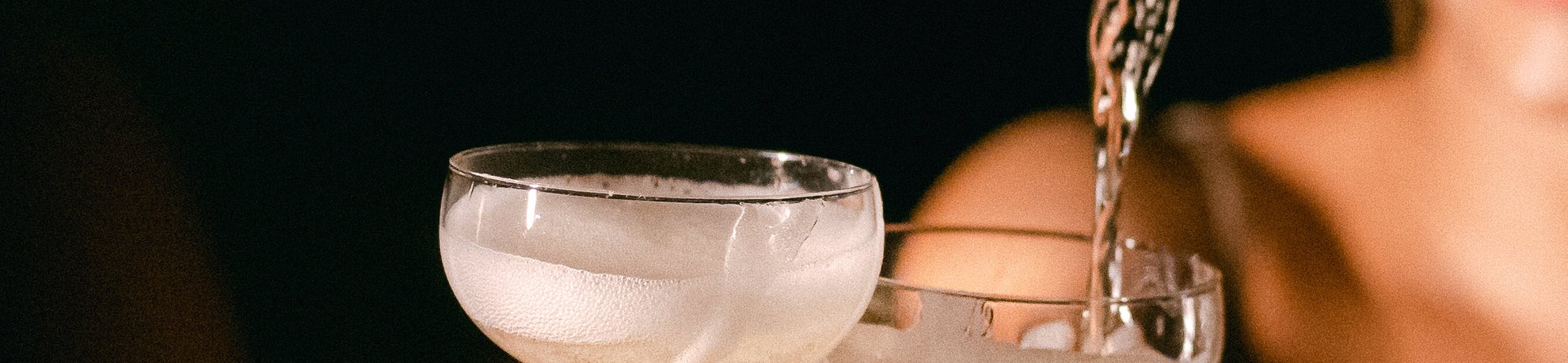 a woman pouring champagne into a glass, creating a sparkling cascade of bubbles and celebration at selva the emily hotel