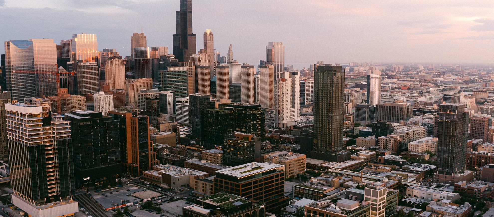 aerial view of Chicago during sunset with high rise buildings, Willis Tower from Fulton Market neighborhood