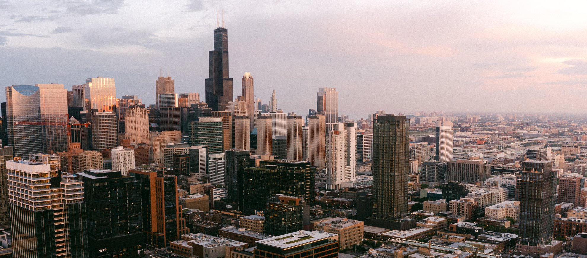 aerial view of Chicago during sunset with high rise buildings, Willis Tower from Fulton Market neighborhood