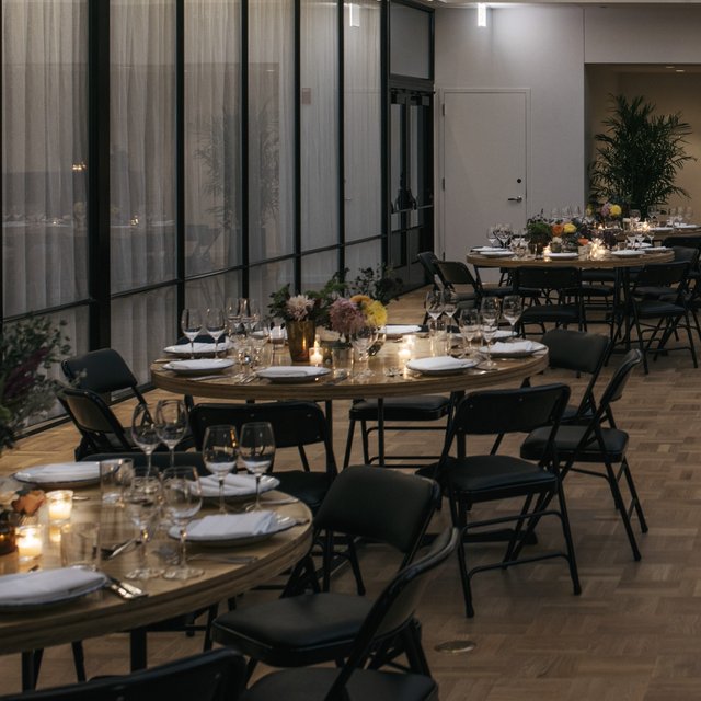 burroughs meeting space at the emily hotel set up for a banquet with round tables and glasses_cropped