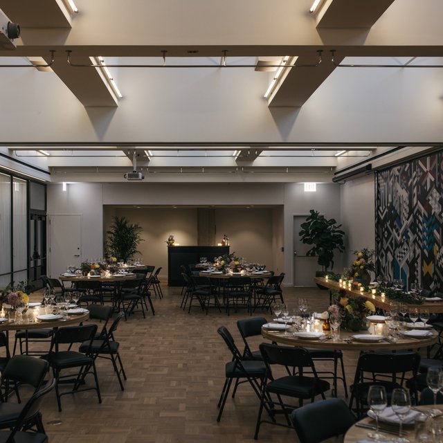 burroughs meeting space at the emily hotel set up for a banquet with round tables and glasses