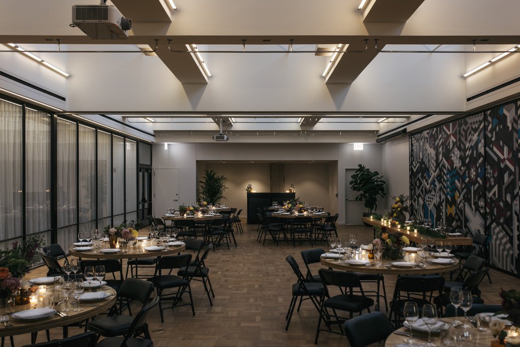 burroughs meeting space at the emily hotel set up for a banquet with round tables and glasses