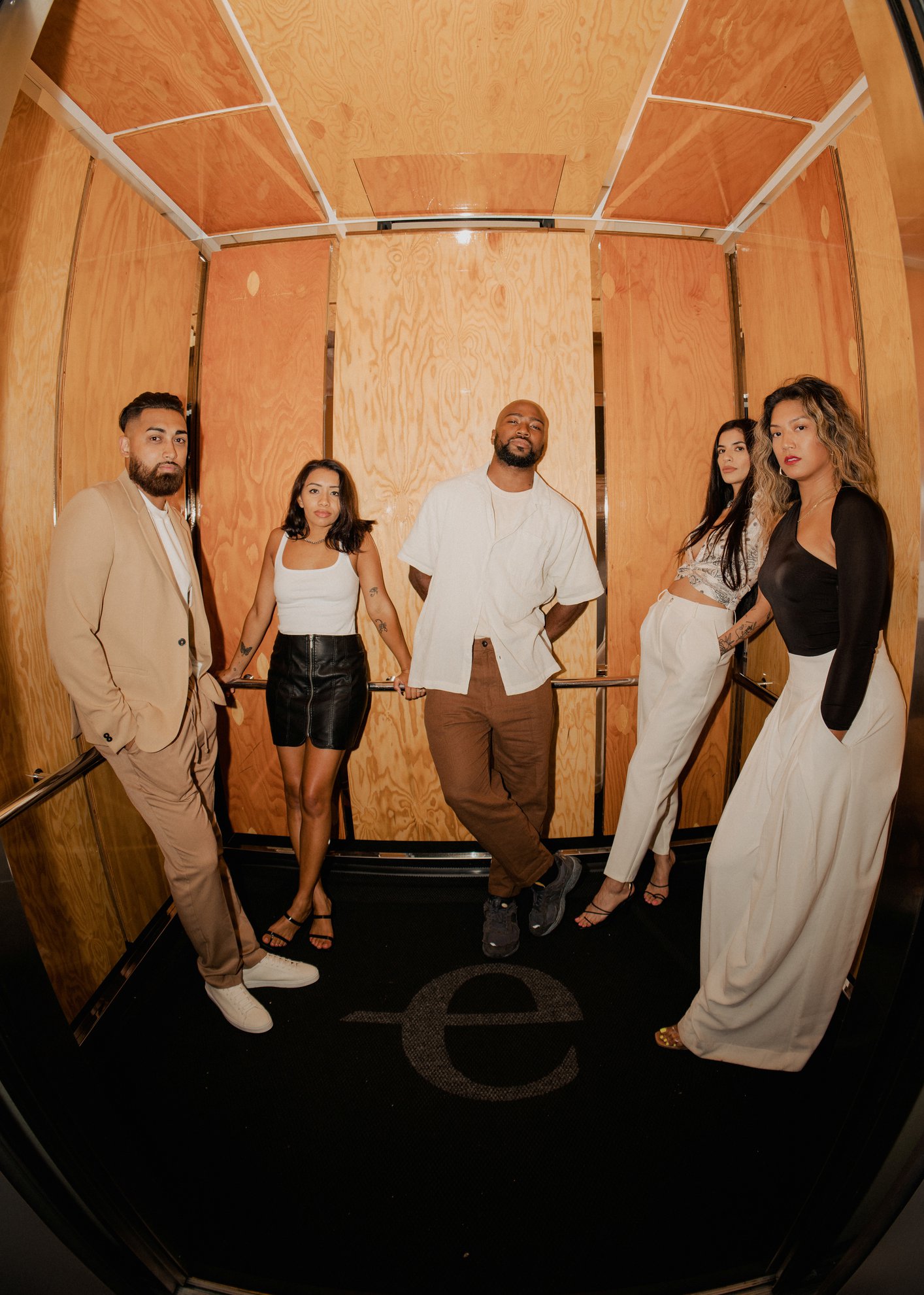 five people in the elevator dressed up going for a night atselva (1)