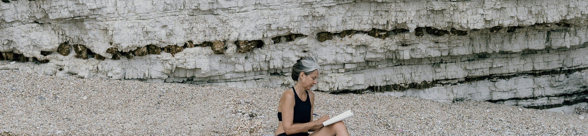 Girl sitting on beach in Puglia