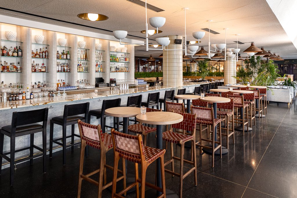 high top tables and the main bar at fora restaurant at the emily hotel