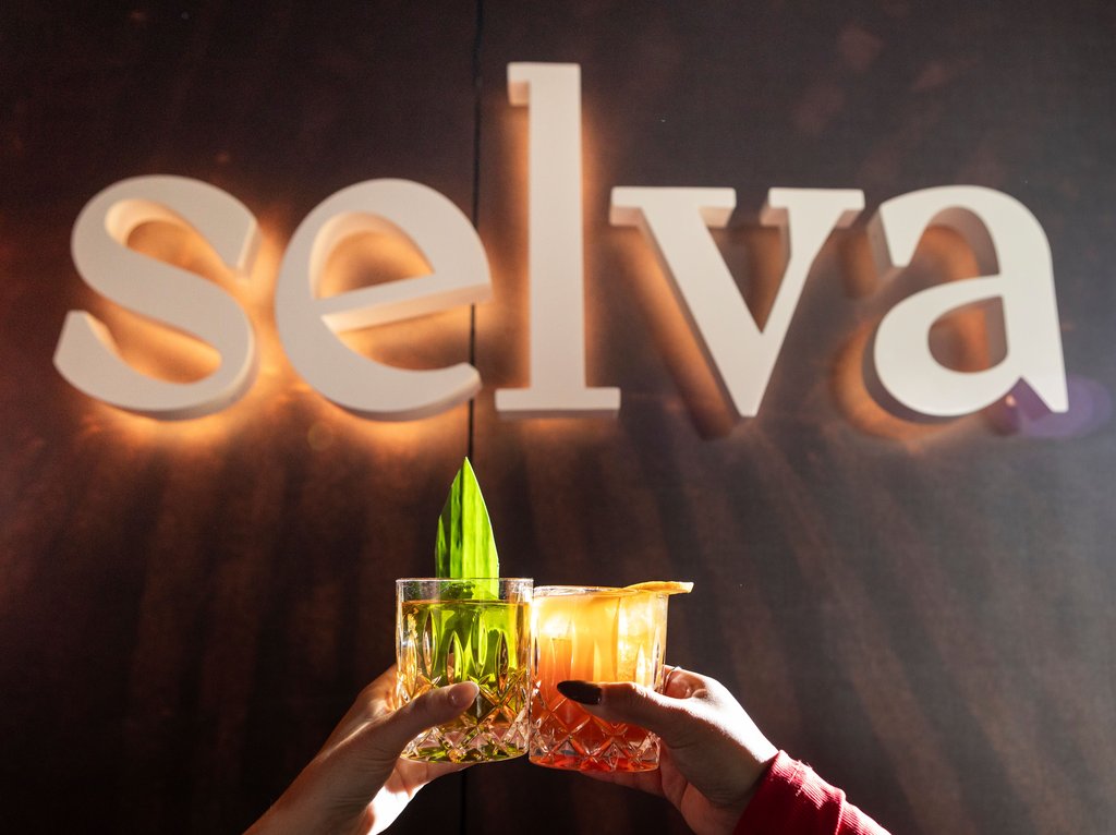 photo of two signature cocktails in front of selva sign at the emily hotel chicago