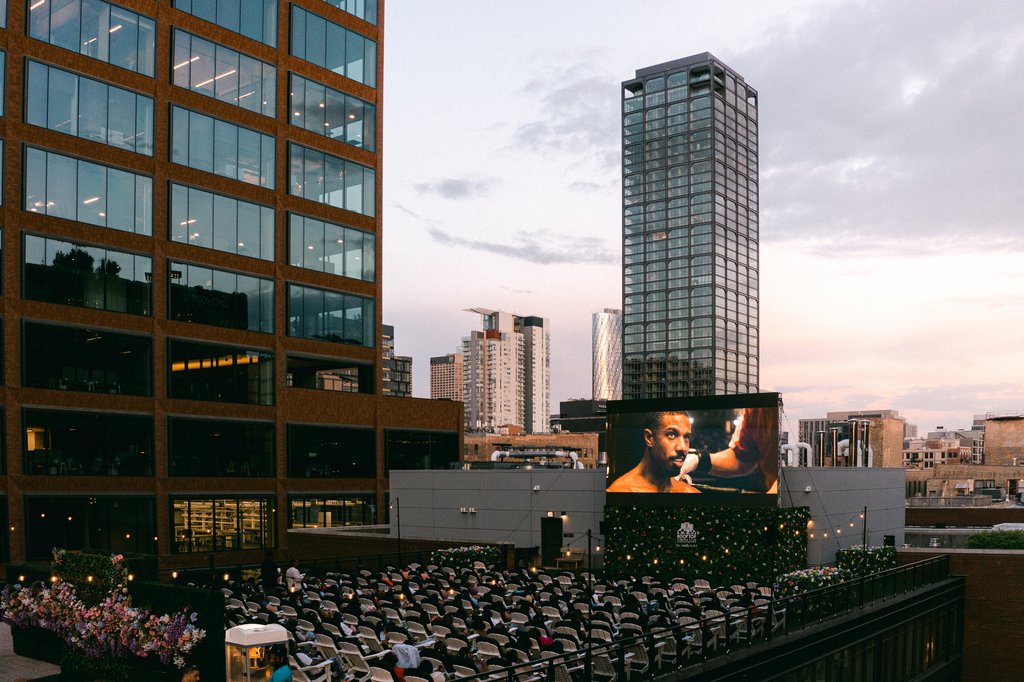 rooftop cinema club at the emily hotel fulton market chicago screening the movie with bunch of guests enjoying the screening