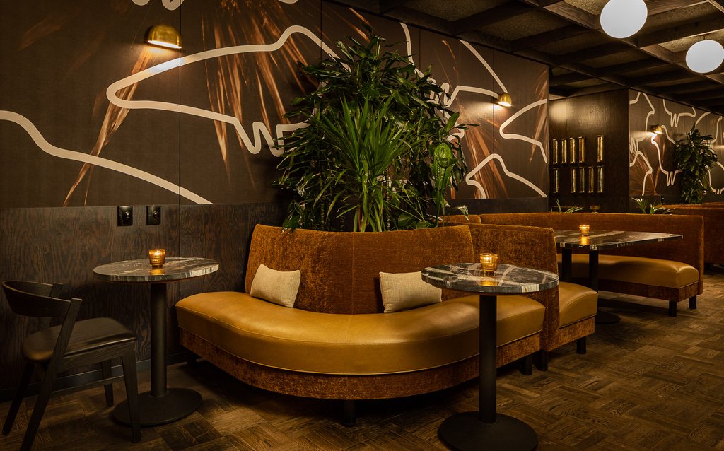 yellow leather booths in the dining area at selva in the emily hotel