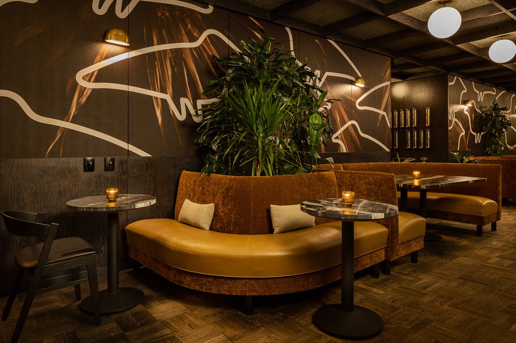 yellow leather booths in the dining area at selva in the emily hotel